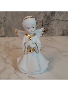Vintage boy angel figurine holding horn trumpet